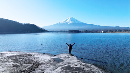 Traveler Celebrating the View of Mount Fuji by Lake Kawaguchi in Japan