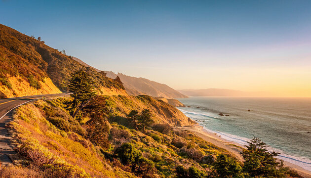 A road winding along the coast in the late afternoon sun with a view of the ocean