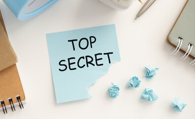 Text Top Secret on paper lying on the office table