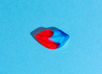Gummy neon lips are red with blue. 