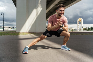 Person Exercising Outdoors Under a Bridge During Cloudy Weather, Engaging in a Lateral Stretch Routine