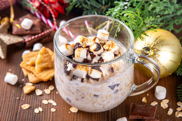 Overnight s`mores oatmeal, Christmas, winter holiday tasty breakfast healthy idea with oats, yogurt, marshmallow, chocolate and creamy sauce