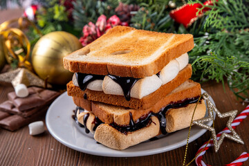 S`mores toasted bread sandwiches with a lot of toasted roasted marshmallow, melted chocolate, Christmas winter tasty breakfast or snack idea, copy space