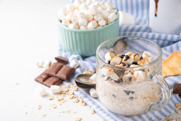 Overnight s`mores oatmeal, Christmas, winter holiday tasty breakfast healthy idea with oats, yogurt, marshmallow, chocolate and creamy sauce