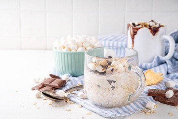 Overnight s`mores oatmeal, Christmas, winter holiday tasty breakfast healthy idea with oats, yogurt, marshmallow, chocolate and creamy sauce