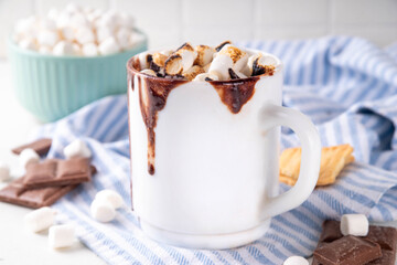 Mug with S`mores hot chocolate or coffee, thick smores hot cocoa or latte drink with toasted marshmallow, graham cracker and chocolate topping