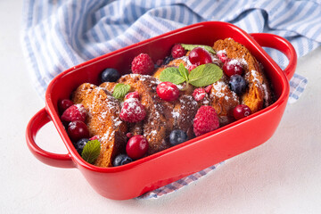 Christmas Morning French Toast Baking, holiday morning french toast casserole, sweet simple dessert with bread, egg and milk mixture and fresh berries