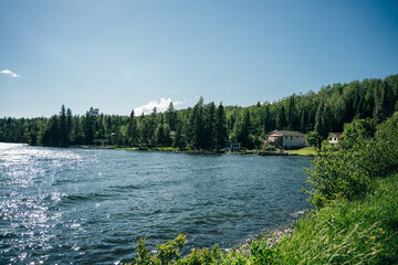 Imagery with small lakes, forest and beautiful blue sky with big puffy clouds in Summertime.