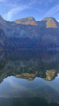 vertical view of lake waters. Fresh air, blue sky along the horizon, mountain skyline, picturesque fishing villages Famous tourist region. Austria