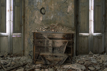 There is a room that contains a dresser and two windows positioned in it