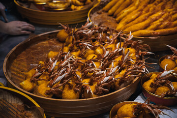 Chinese fried crabs in a basket displayed in a popular street market in Nanjing Road at night, Shanghai, China