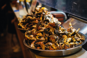 Tray with crab claws at Chinese restaurant specialized in seafood where workers peel crab meat in front of customers to prepare dishes like crab noodles or dumplings, very popular in China, shanghai