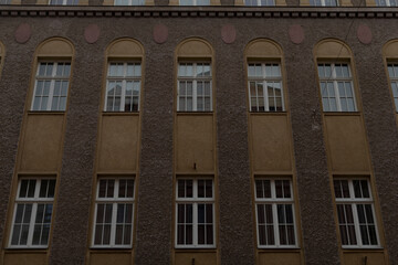 Obraz premium This is an exterior view of an impressive historic building facade that beautifully showcases its numerous windows along with various classic architectural details that contribute to its charm