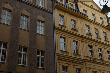 A captivating side view of historic buildings is on display, showcasing their elegant gray and yellow facades that highlight the intricate and beautiful architectural design of the structures