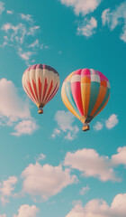 Naklejka premium Colorful hot air balloons floating over a green field against a blue sky on a sunny day