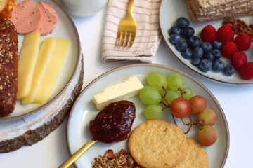 Assortment of various breakfast foods and drinks on the white table. Selective focus.
