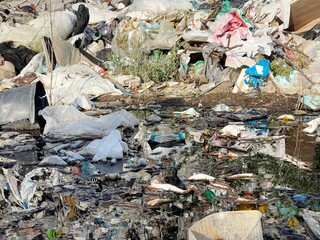 Water pollution by waste. Landfill on a flowing river. Groundwater pollution.