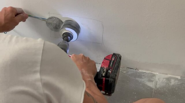 Wall outlet installation by an electrician in a residential building during electrical work