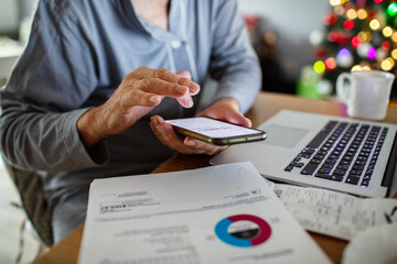 Senior man managing finances online during Christmas at home