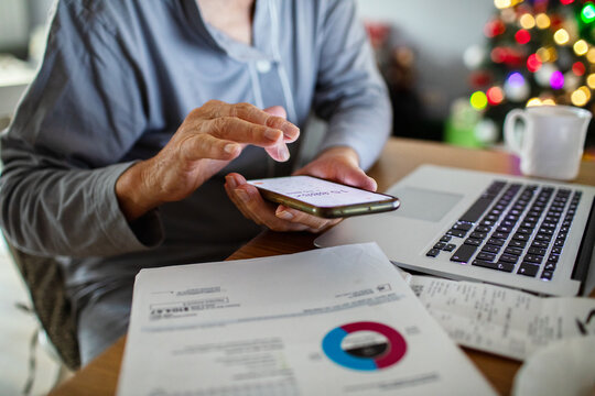Senior man managing finances online during Christmas at home