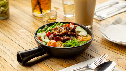 Beef Black Pepper Poke Bowl served on the table with Cappuccino and Iced Tea
