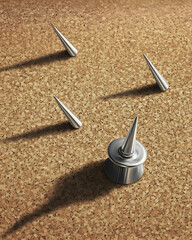 Metal spikes on corkboard.