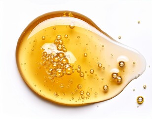 golden honey or clear yellow gel serum smear with bubbles isolated on white background top view