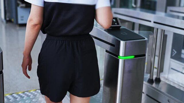 Woman holding mobile phone scanning enters checkpoint, slow motion video