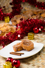 Traditional brazilian christmas Rabanadas with egg yolk crea and cinnamon, Spanish Torrijas on golden plate on a christmas dinner table