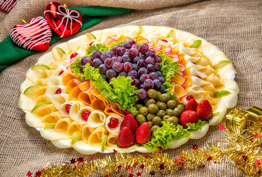 snack board, cheese Platter with fruits and olives, tray on a Christmas dinner table ( tábua de frios ) - Powered by Adobe