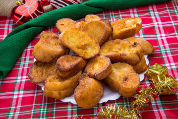 Traditional brazilian christmas Rabanadas with egg yolk crea and cinnamon, Spanish Torrijas on a christmas dinner table