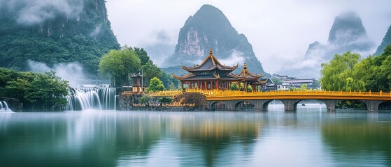 Majestic golden architecture by tranquil water surrounded by lush mountains at sunset in an idyllic location