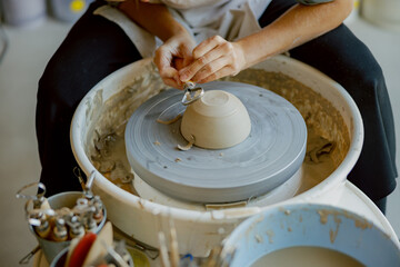 An Artisan Skillfully Crafting a Beautiful Clay Bowl on a Pottery Wheel in their Studio