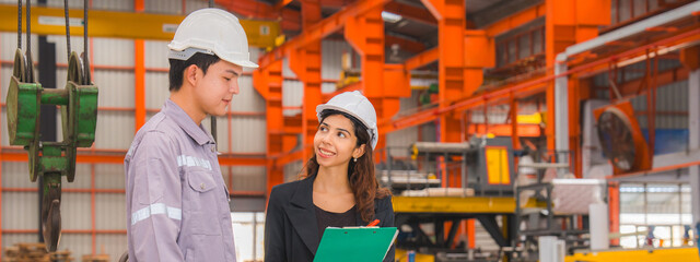 A male expertise engineering is explaining about the quality of metal sheet machine of industry to...