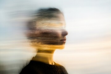 Blurry profile of person, abstract, motion, surreal effect.