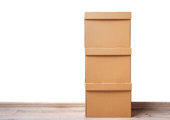 Mailing cardboard boxes on the floor against a white wall.