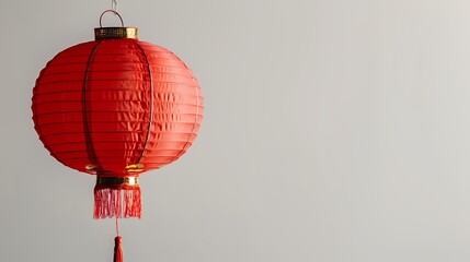 Obraz premium A vibrant red lantern with intricate details, symbolizing celebration and culture, hanging against a plain background.