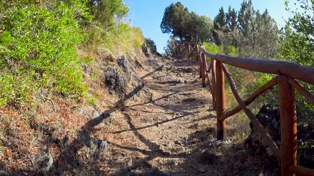Sun-drenched track to the cliff top from the beach in the bay of Marina di Camerota, Salerno, Italy.
