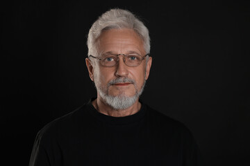 Obraz premium Portrait of senior man on black background