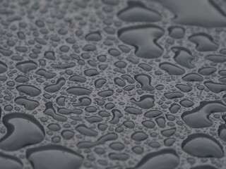 Water droplets on a surface after rain forming an abstract pattern