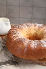 Freshly baked sponge cake and milk on table, closeup