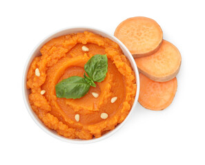 Tasty mashed sweet potato with basil, seeds in bowl and fresh cut vegetable isolated on white, top view