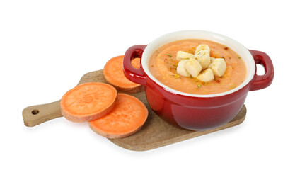 Delicious sweet potato soup with croutons and fresh vegetable isolated on white