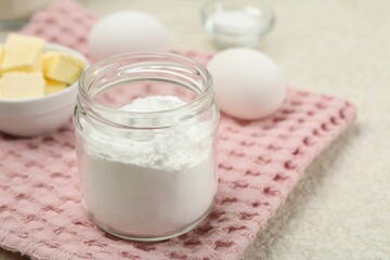 Baking powder and other ingredients for making dough on table, closeup