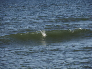 Fototapeta premium Waves on the sea during sunset with light reflections on the water