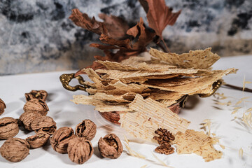 Tarhana cips, crispy snacks a traditional turkish anatolian fermented soup base made into crunchy chips made of youghurt and cereals, served with walnuts