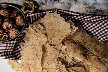 Tarhana cips, crispy snacks a traditional turkish anatolian fermented soup base made into crunchy chips made of youghurt and cereals, served with walnuts