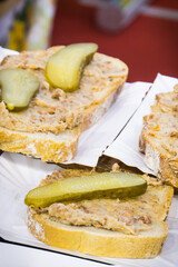 Fresh portion of wheat or rye bread with homemade lard with pickled cucumber