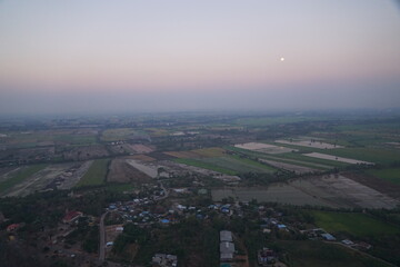 Fototapeta premium Aerial view of agricultural fields at dusk rural area photography calm environment scenic perspective nature's beauty