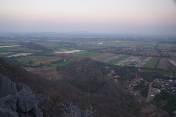 Breathtaking sunset view over rolling fields and mountains scenic landscape nature photography serene environment elevated perspective